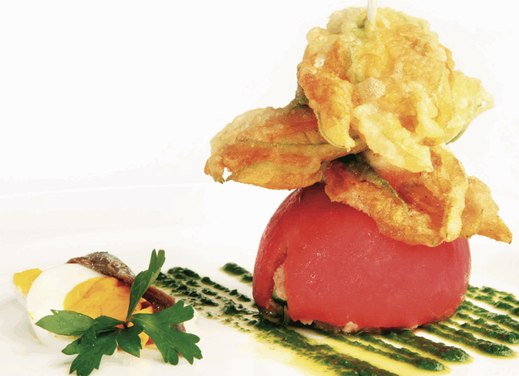 Pomodoro con anima di caponata molisana e spiedo di fiori di zucchina pastellati ripieni di ricotta su emulsione di sedano