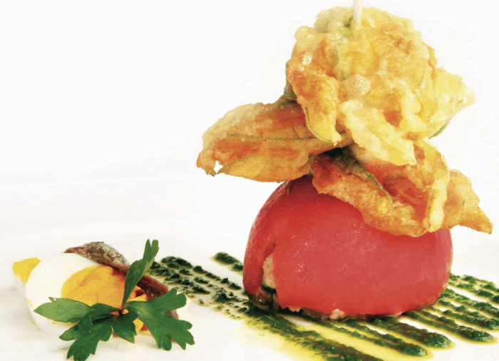 Pomodoro con anima di caponata molisana e spiedo di fiori di zucchina pastellati ripieni di ricotta su emulsione di sedano